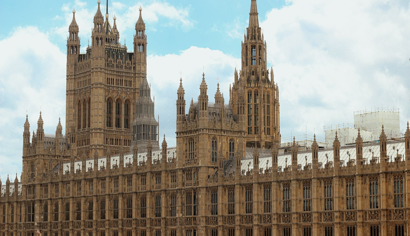 a large building with towers with Palace of Westminster in the background