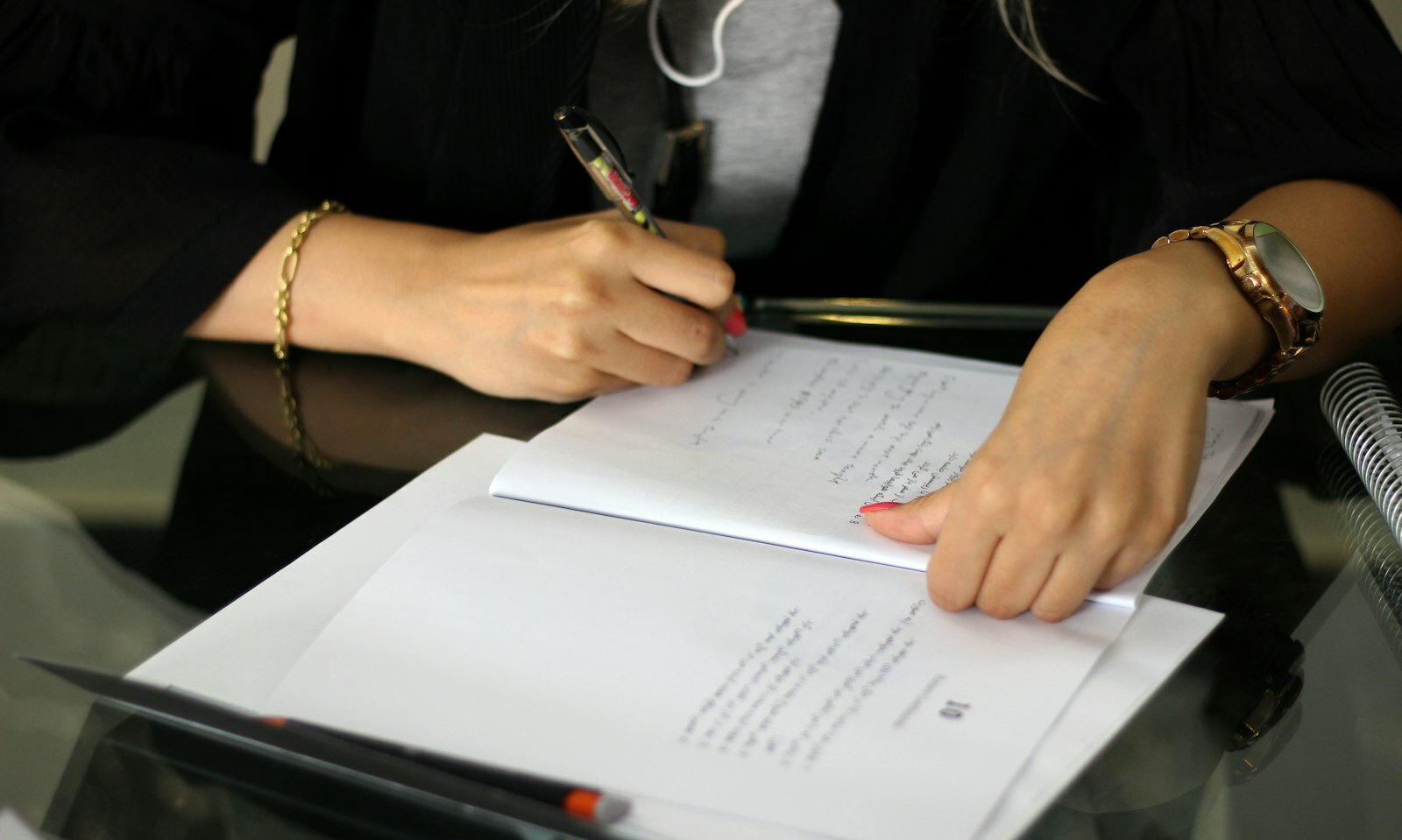 a person writing on a piece of paper